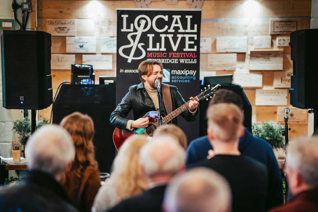 Front man of local band Suncharmer, Paul Crisp, performs at the Local & Live 2024 music festival launch party at The Old Auction House Tunbridge Wells